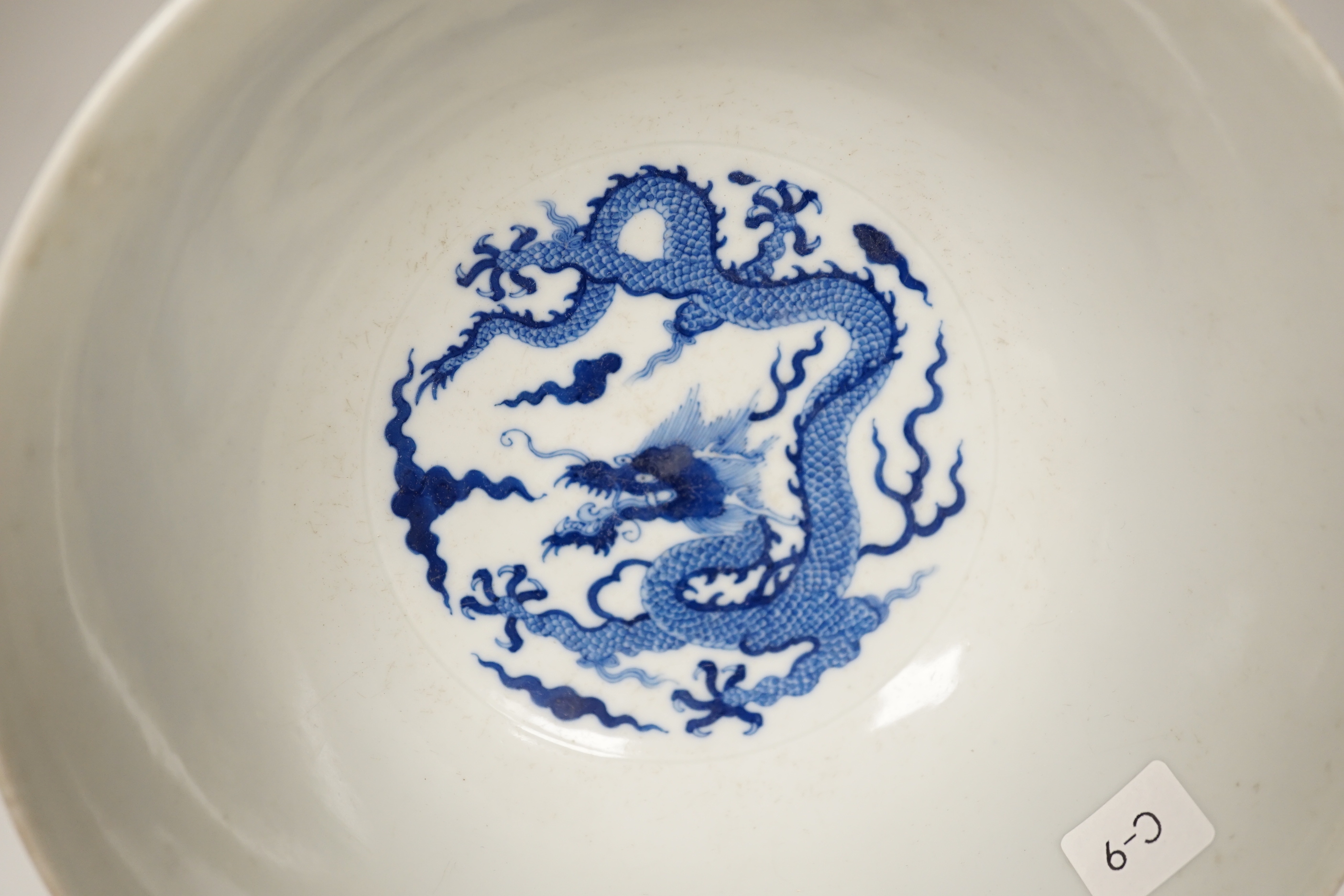 A Chinese blue and white bowl, hand painted with dragons, housed in a fitted case, 18cm in diameter